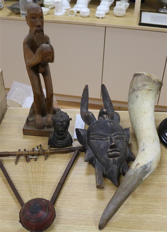An African carved wood Mask, a Benin style bronze bust, a musical instrument, a horn and a wooden figure